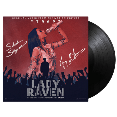 Lady Raven Standard Black Vinyl - SIGNED COPY album cover featuring a dramatic concert scene with a performer on stage against a burgundy and navy backdrop, silhouetted crowd, and autograph signatures. Movie soundtrack vinyl record from TRAP in classic black vinyl format.
