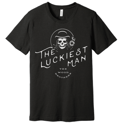 The Luckiest Man black t-shirt featuring skull graphic with hat and daisy design on soft heather fabric