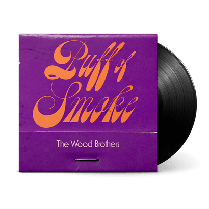 Puff of Smoke vinyl album with purple cover featuring orange script lettering, displayed with black vinyl record