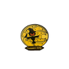 2018 Suwannee Hulaween Pin featuring a black dancing scarecrow silhouette with glowing orange smile against a golden circular moon background, decorated with stars and swirls, with Suwannee 2018 text banner below