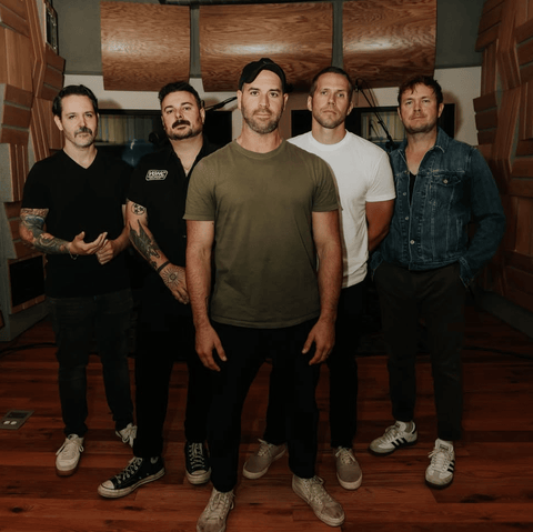 The five members of Conditions standing in the studio