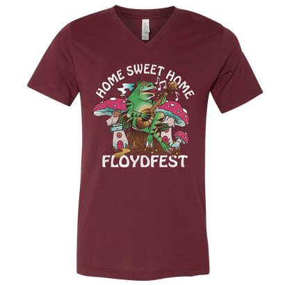 Maroon V-neck t-shirt with colorful FloydFest 'Home Sweet Home' design featuring a cartoon tree playing guitar, mushrooms, and musical notes. Festival-themed graphic in white, green, pink, and blue on burgundy background.