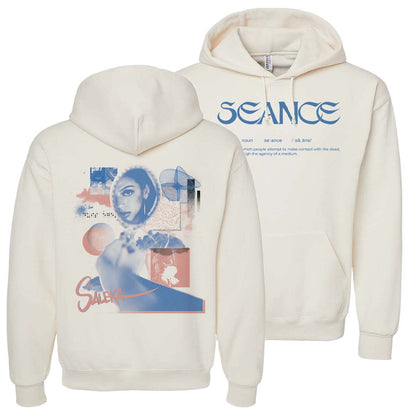 Saleka Seance Mirror Hoodie in cream white cotton-polyester blend featuring artistic blue and coral graphics on back and Seance text logo on front. Premium pullover with kangaroo pocket and adjustable drawstring hood.