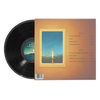 Vinyl record partially pulled from sleeve showing a glowing candle framed by a window with landscape and song list on back cover