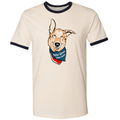 PB Sadie Mae Ringer Tee featuring a cheerful dog illustration wearing a bandana on cream-colored cotton t-shirt with navy trim on collar and sleeves. Classic ringer style design with playful pet graphic.