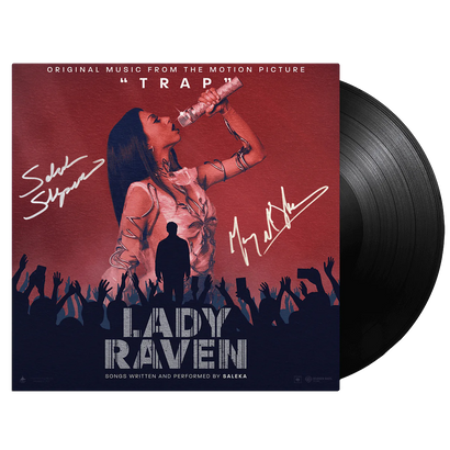 Lady Raven Standard Black Vinyl - SIGNED COPY album cover featuring a dramatic concert scene with a performer on stage against a burgundy and navy backdrop, silhouetted crowd, and autograph signatures. Movie soundtrack vinyl record from TRAP in classic black vinyl format.