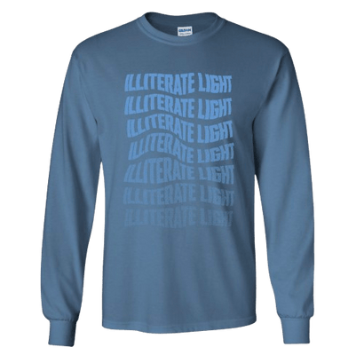 Blue long-sleeve shirt with stacked distorted text reading Illiterate Light in varying shades of blue on front