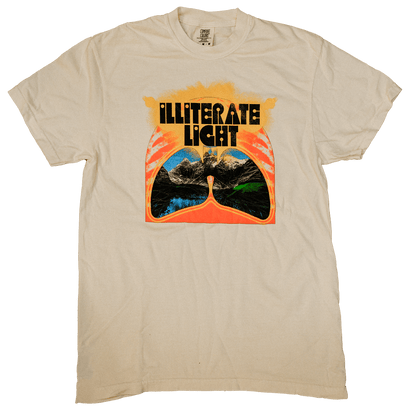 Beige shirt featuring stylized lungs with mountain landscape inside and bold retro text reading Illiterate Light above