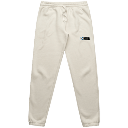 Natural-colored sweatpants with drawstring waist and tapered legs, featuring HULA logo printed on left thigh. Comfortable and casual style for everyday wear.