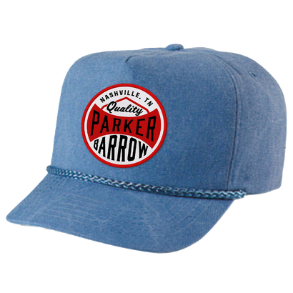 Stone-washed blue canvas cap with structured crown and snap closure. Features Parker Barrow logo patch and retro rope detail. Nashville, TN quality 5-panel design.