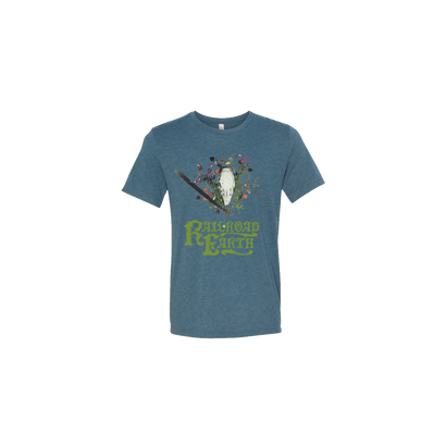 2020 Winter Tour Tee in slate blue featuring artistic design of white animal skull, delicate feather, and colorful flowers on branch against heathered fabric. Railroad Earth band logo in green text below nature-inspired illustration.