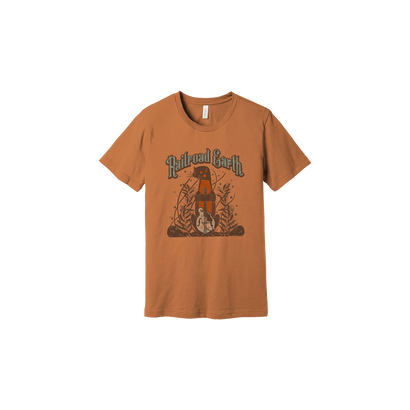 Winter Tour Otter Tee 2023 featuring a whimsical design of an otter playing electric mandolin amidst decorative foliage on a burnt orange Bella + Canvas triblend t-shirt. The illustration shows the otter sitting on a log in a vintage-inspired style.