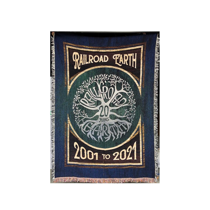 20th Anniversary Throw Blanket featuring Railroad Earth tree logo in navy and green, with dates 2001 to 2021. Cotton woven blanket with decorative fringe border displays circular tree design celebrating two decades of music legacy.