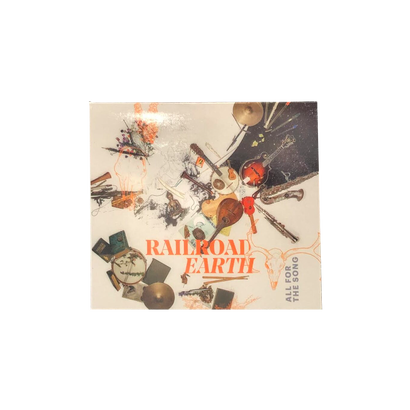 Railroad Earth's All For The Song CD album cover featuring an artistic collage of musical instruments including banjos, drums, and strings scattered in an abstract composition with orange and beige tones against a light background