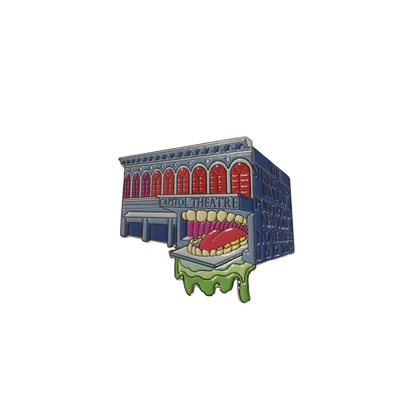 2014 Port Chester Capitol Theater Pin featuring a whimsical design of the historic theater building with a playful monster mouth entrance, rendered in vibrant red, blue and green colors. Limited edition collectible enamel pin from The String Cheese Incident concert series.