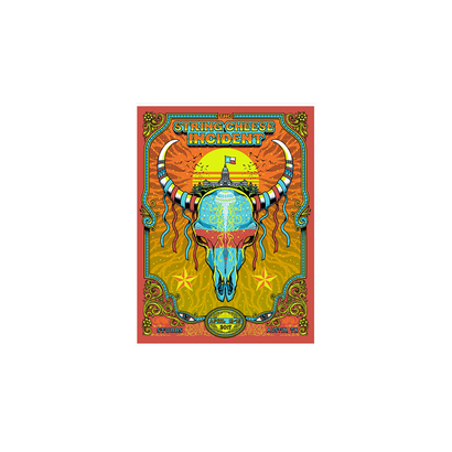 2017 Austin TX Poster featuring vibrant psychedelic artwork with a decorated bull skull design in turquoise and orange. Ornate border frames a desert sunset scene with yellow and red hues. Limited edition concert poster by Matt Leunig for String Cheese Incident.