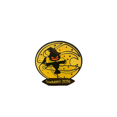 2018 Suwannee Hulaween Pin featuring a black dancing scarecrow silhouette with glowing orange smile against a golden circular moon background, decorated with stars and swirls, with Suwannee 2018 text banner below