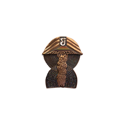 2018 Red Rocks Pin featuring a stylized copper-toned design of the iconic amphitheater with concentric circular patterns and architectural details, set against a dark background with metallic finish, limited edition collectible for The String Cheese Incident concert series