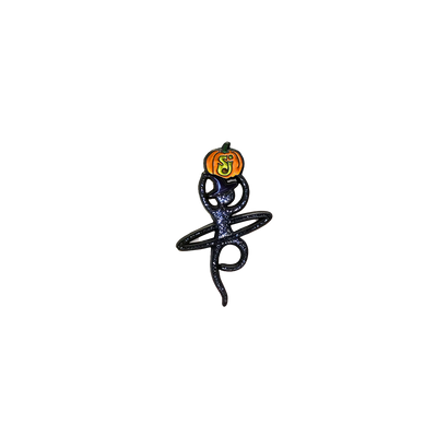 2019 Hulaween Pin featuring a whimsical black figure spinning a hula hoop with an orange and yellow glowing pumpkin balanced atop, designed in a stylized enamel pin format with cosmic sparkle details.