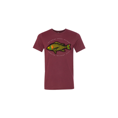 Jamaica Incident 2022 Red Snapper T-Shirt featuring a vibrant red snapper fish illustration on a burgundy cotton tee. The fish design is centered within circular text, showcasing detailed green and orange coloring in a vintage-inspired style.