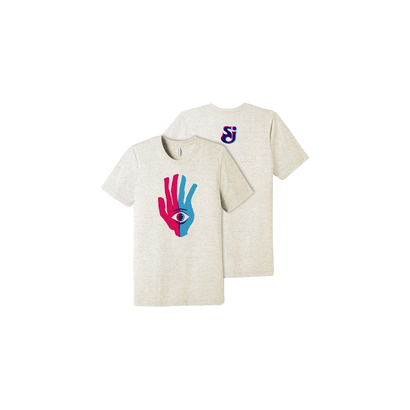 Lend Me A Hand T-Shirt in oatmeal color featuring a vibrant pink and blue hand design with an eye symbol on the front, and a small SCI logo on the back. The unisex t-shirt showcases artistic graphics inspired by The String Cheese Incident's 8th studio album.