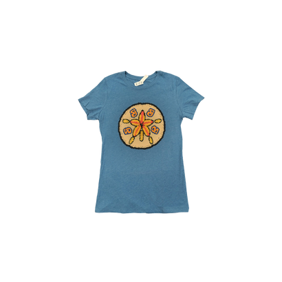 Women's Sand Dollar Tee in heather deep teal featuring a large circular design with an orange starfish-like sand dollar graphic centered on the chest. The slim-fit t-shirt displays The String Cheese Incident's signature logo against the soft cotton-polyester blend fabric.