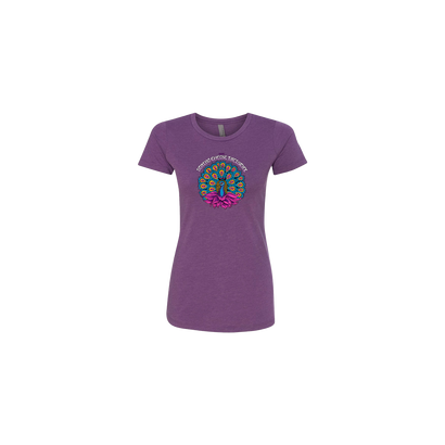 Women's Peacock Purple t-shirt featuring a vibrant circular peacock design in turquoise, blue, and pink colors centered on a rich purple fitted crew neck tee. The String Cheese Incident artwork showcases a detailed peacock feather mandala pattern on soft cotton fabric.