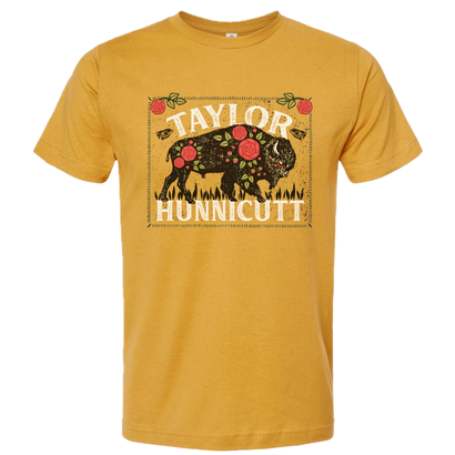 Gold t-shirt with rectangular buffalo graphic, floral treatment with taylor hunnicutt text