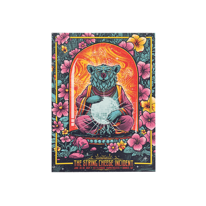 Colorful illustration of a meditating bear with headphones, surrounded by flowers, promoting a String Cheese Incident concert poster.